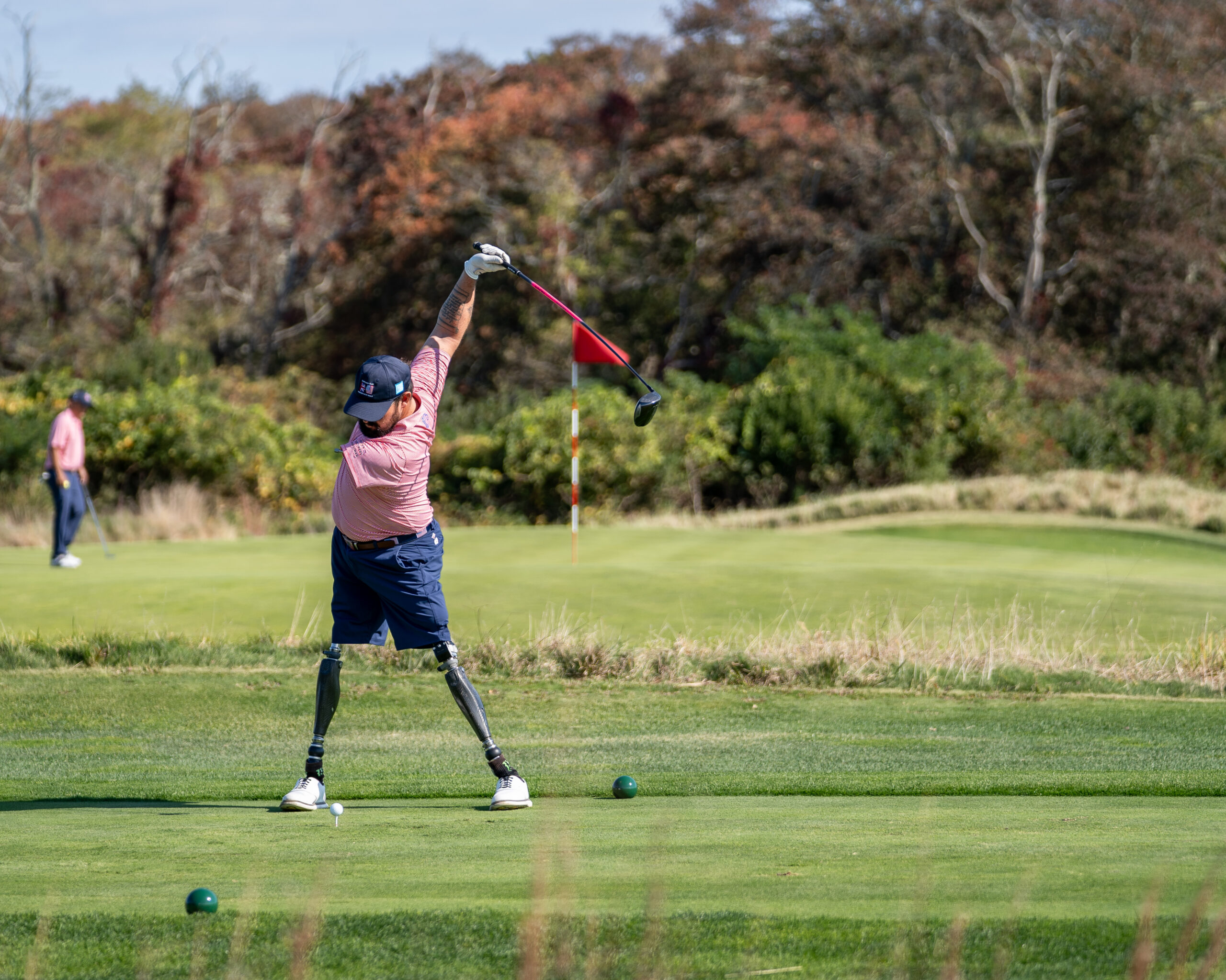 A wounded veteran golfer drives off the tee — On Course Foundation